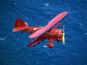 Red Plane Fly Above Sea