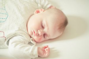 White Cute Baby Sleeping on Bed Wallpaper
