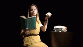 Girl Reading Stuffing Herself With Popcorn Funny Animated Gif